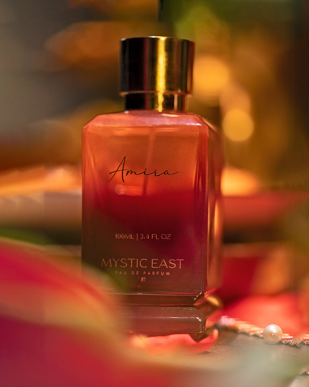 Amour Mystic East perfume bottle with a blurred background