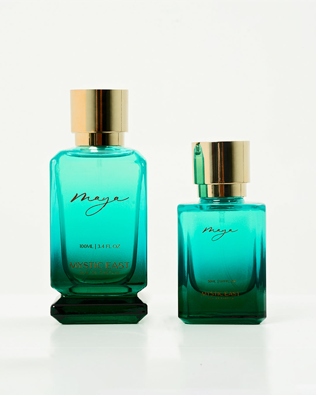 Two teal perfume bottles with gold caps on a white background